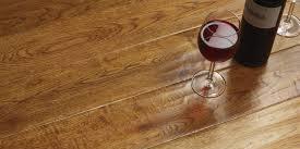 glass of red wine on laminate flooring